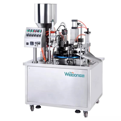 Macchina automatica per il riempimento e la sigillatura di tubi per crema azionata pneumaticamente